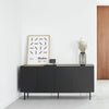 Modern interior with a black sideboard, wooden door, and minimal decor.