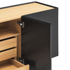 Close-up of a modern cabinet with a matte black door and light natural wood interior and drawer fronts, shown open on a white background.