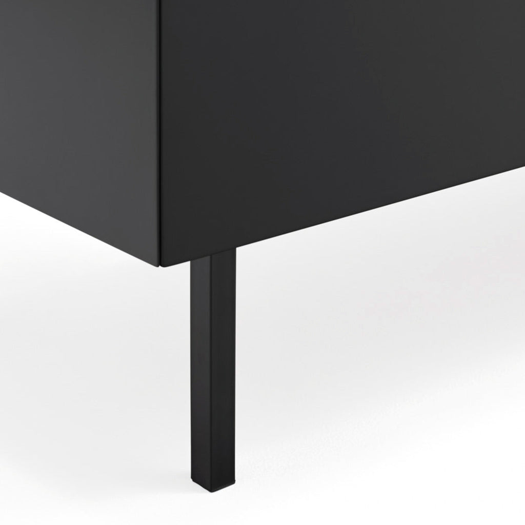 Close-up of a modern black cabinet or sideboard with a single slim black leg, shown against a clean white background.