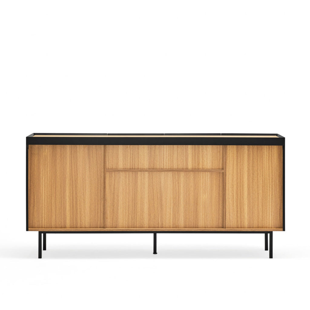 A mid-century modern sideboard cabinet with light wood grain doors, a black top surface, and slim black metal legs, shown against a plain white background.