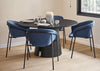 Dining room with a round black table and blue chairs, featuring a modern chandelier.