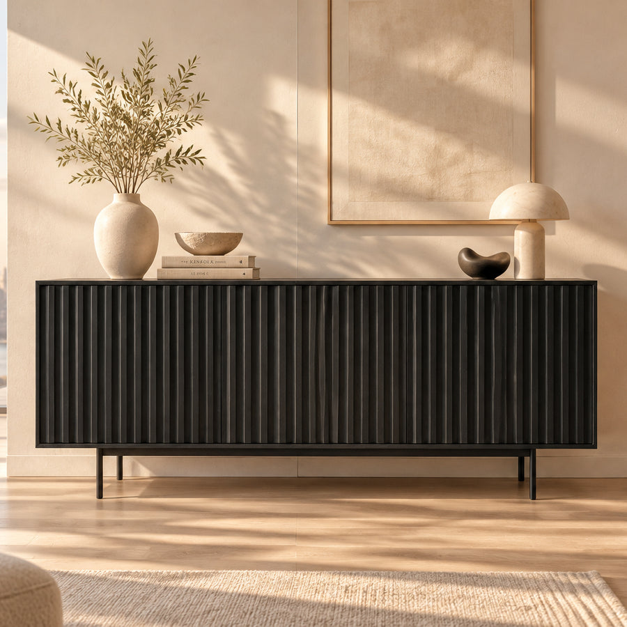 A modern black sideboard cabinet with a ribbed vertical front panel and slim legs, shown against a plain white background.