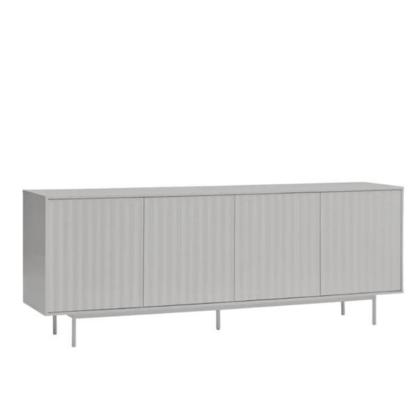 A long, low sideboard cabinet with four vertically ribbed doors, shown in a light gray finish on a plain white background.