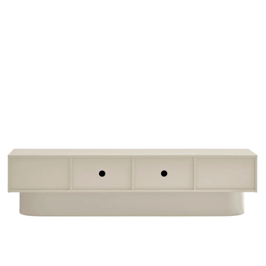 A modern low-profile media console or sideboard in a light warm beige finish, featuring two front-facing drawers with small round black knobs and a sculptural tiered base, shown against a plain white background.