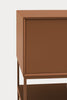 Close-up of a modern sideboard cabinet with a warm terracotta brown finish, showing the top surface, front door, and lower shelf against a light gray background.