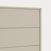 Close-up of a light beige or warm gray dresser drawer front with thin dark line accents and a subtle shadow, set against a very light neutral background.