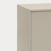 Close-up of a minimalist cabinet corner with a smooth, matte beige finish against a clean white background.