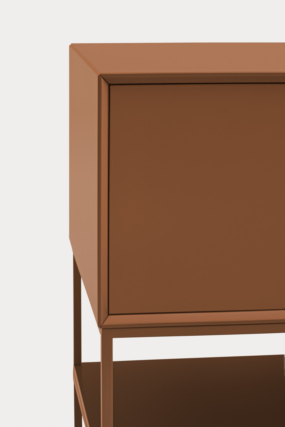 Close-up of a modern sideboard cabinet with a warm terracotta brown finish, showing the top surface, front door, and lower shelf against a light gray background.