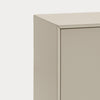 Close-up of a minimalist cabinet corner with a smooth, matte beige finish against a clean white background.