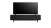 A modern black TV stand with a ribbed front and slim legs, supporting a large black flat-screen television, shown against a plain white background.
